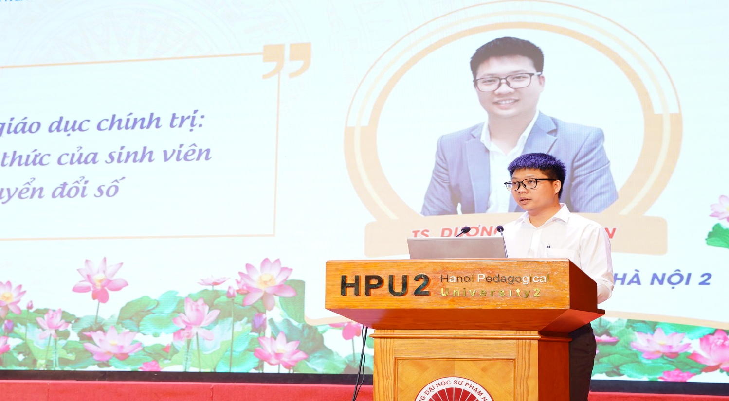 A person standing at a podium
Description automatically generated