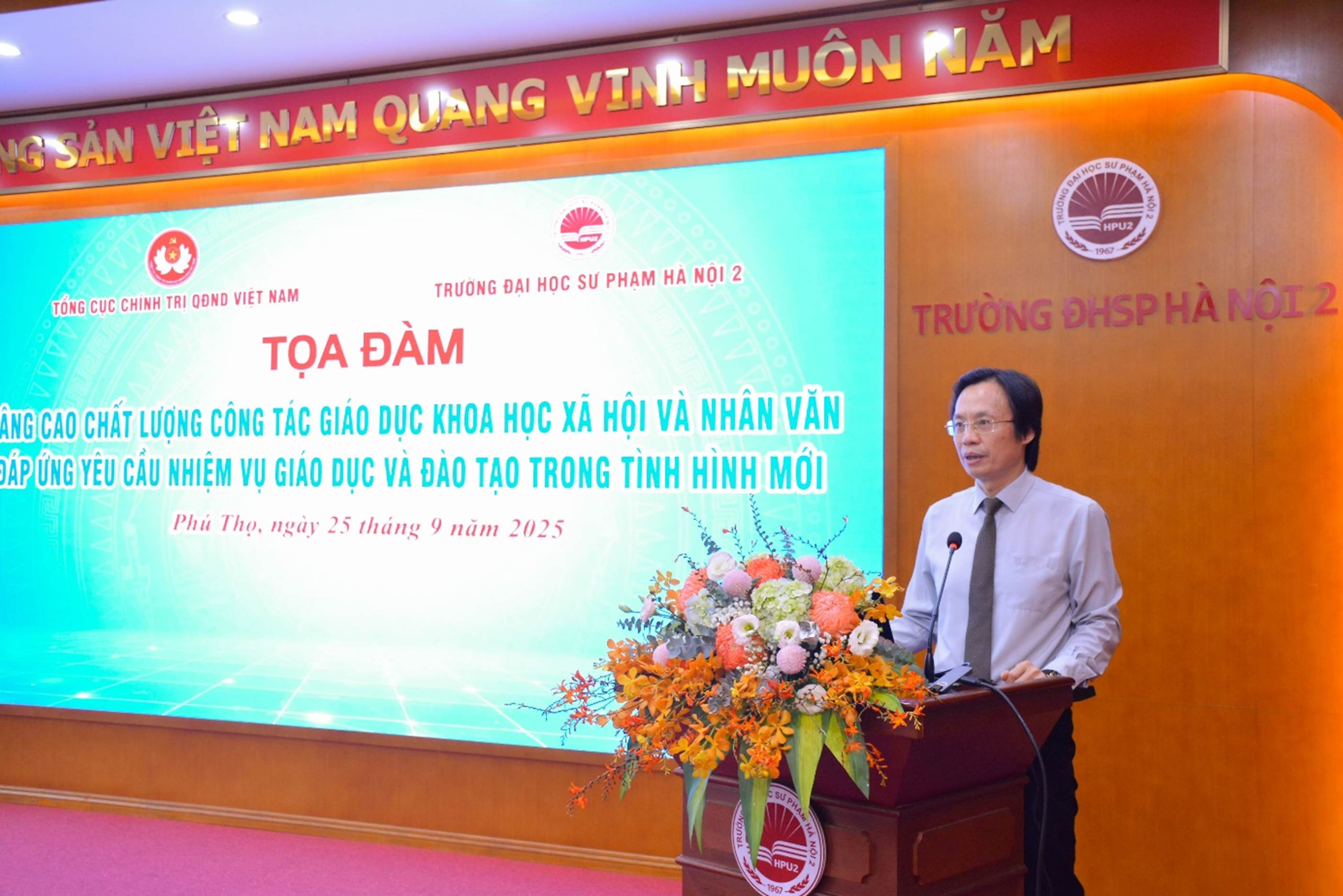 A person standing at a podium with a large screen

AI-generated content may be incorrect.