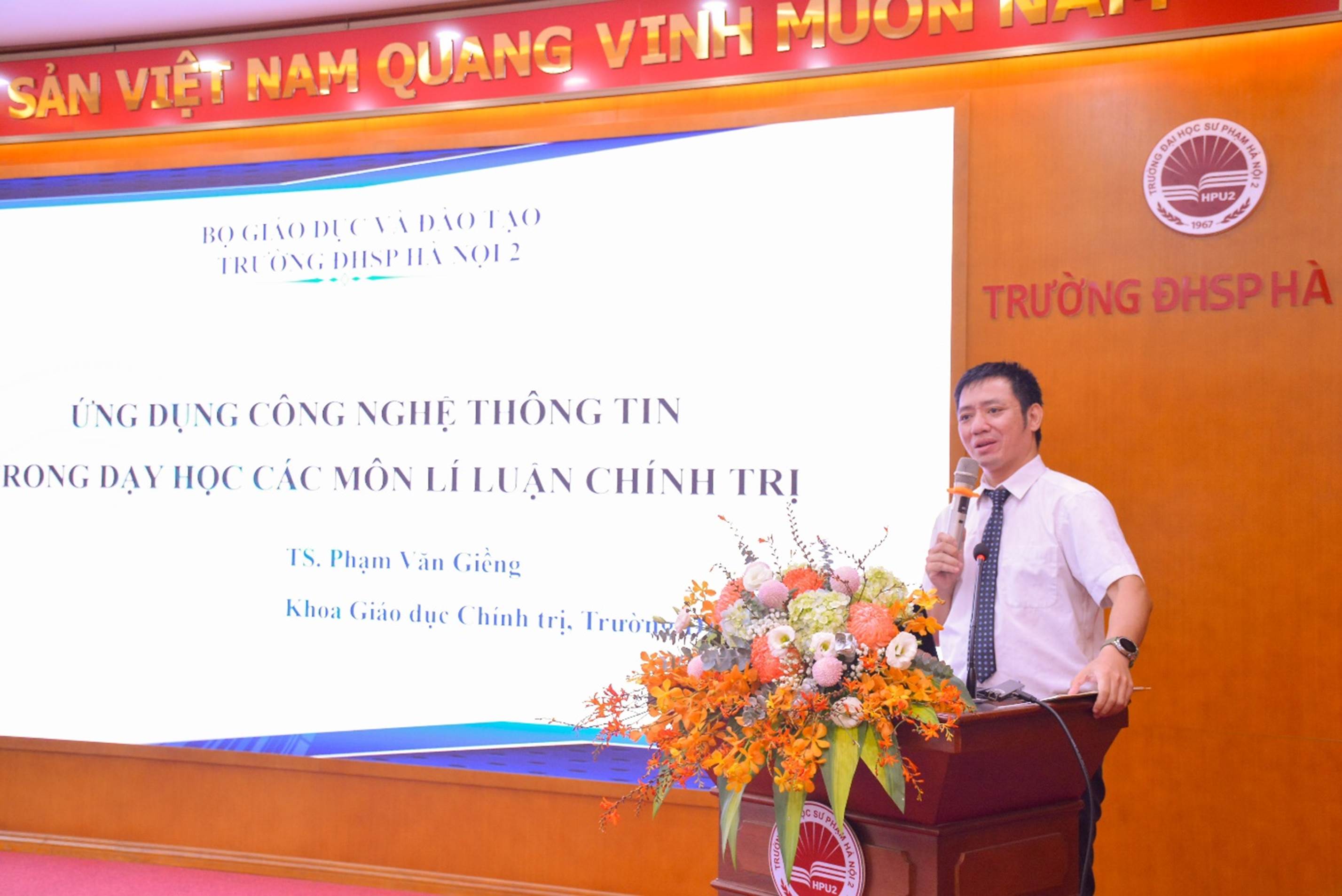 A person standing at a podium with a microphone

AI-generated content may be incorrect.