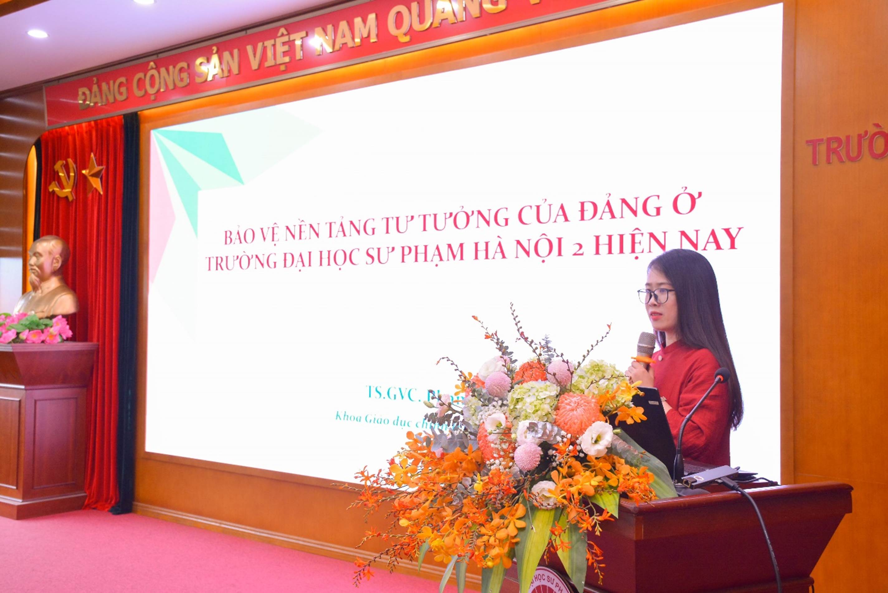 A person standing at a podium with a microphone

AI-generated content may be incorrect.